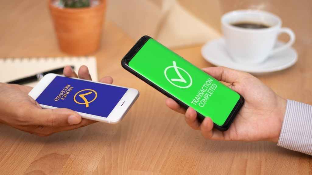Hands Holding A Phone With Green Screen